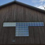 Cedar siding and glass blocks brings in light from the sun