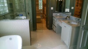 Custom floor and wall installed with designer tiles. Marble countertops and shower with custom 1/2'' frameless shower door.