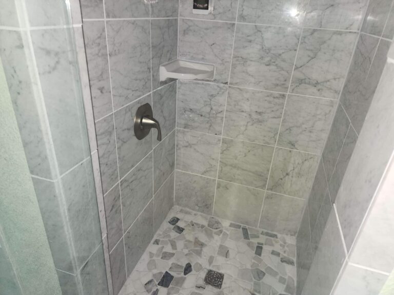 Carrara Marble Shower With Pebble Tile Floor